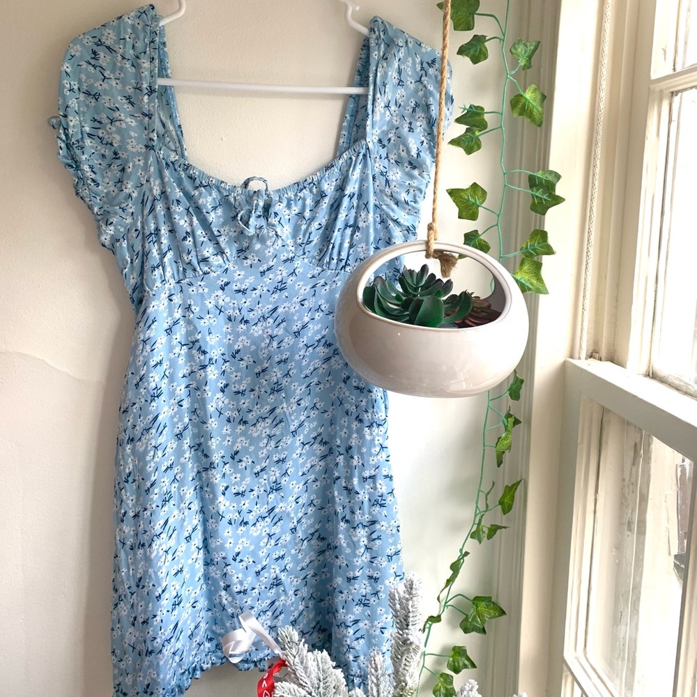 baby blue short sleeved ruffled, mini dress, with floral print.